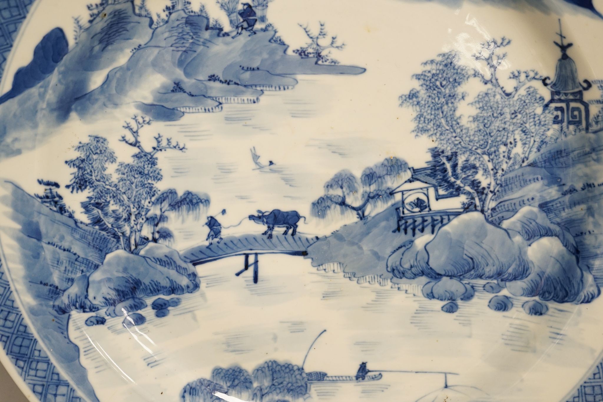 A Chinese blue and white landscape dish, Kangxi mark but 19th century, 36cm